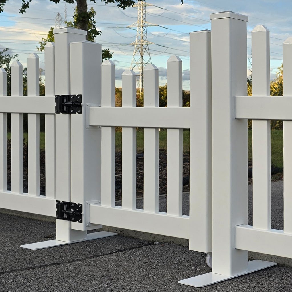 White picket fence with a gate in an outdoor setting