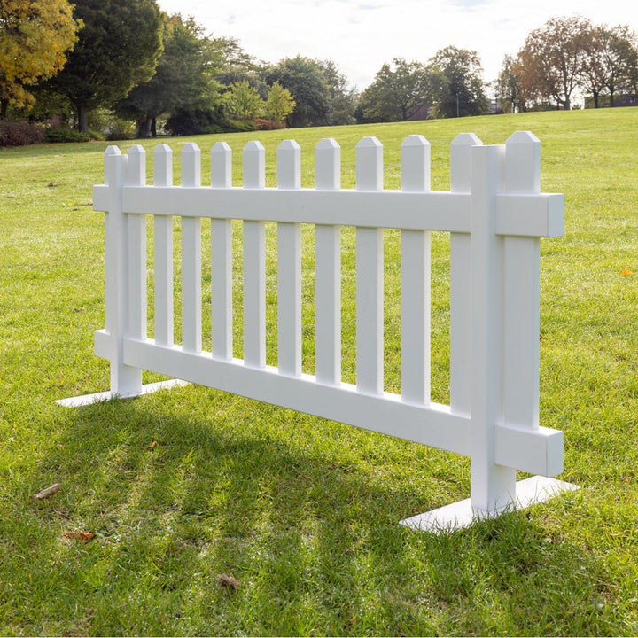 Close-up of portable white picket fence panel with heavy duty steel mounts, 6ft x 2ft 8in vinyl fencing by Simple Fencing.