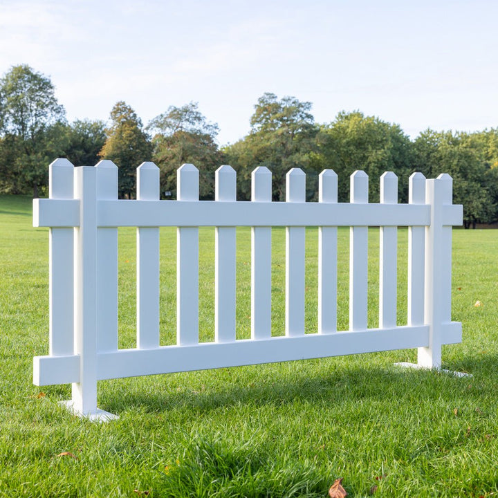 Durable white vinyl portable picket fence panels with steel mounts, 6ft x 2ft 8in temporary fencing by Simple Fencing.