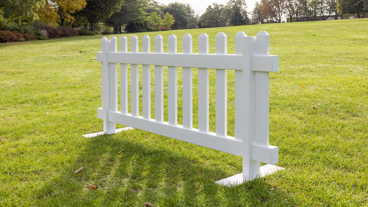 Classic portable picket fence panel in white vinyl with strong steel mounts, 6ft x 2ft 8in event fencing by Simple Fencing.