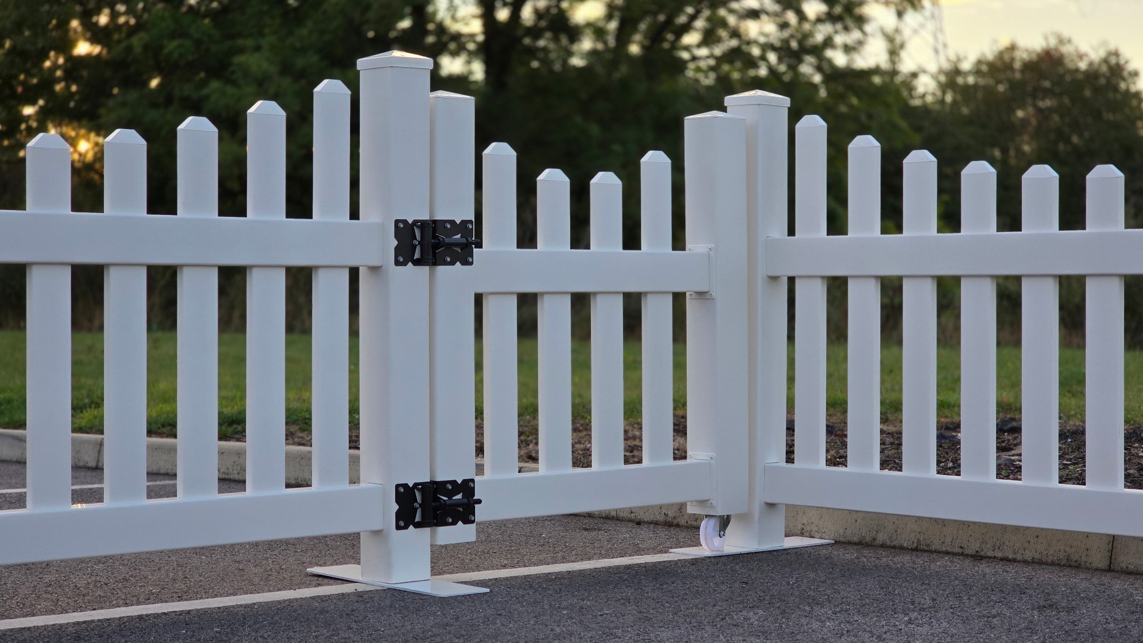 Side view of classic scalloped picket gate, 3ft x 3ft, shown closed in an outdoor setting with a portable fence panel, set against a blurred natural background.
