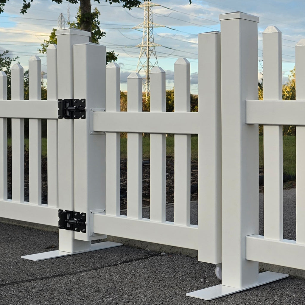 White picket fence with a gate in an outdoor setting