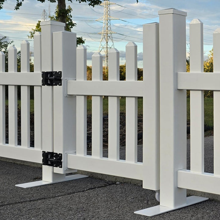 White picket fence with a gate in an outdoor setting